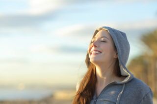 woman with hoodie smiling