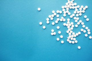 white pills over a blue background