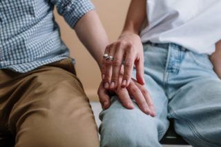Photo Of People sitting touching Hands