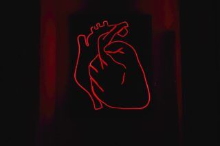 red drawing of heart on black background