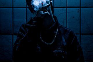 silhouette of man smoking in dark room