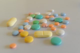 white yellow and teal medication pill